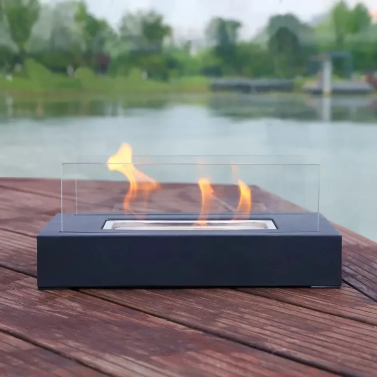 Rectangular tabletop ethanol fireplace operating outdoors