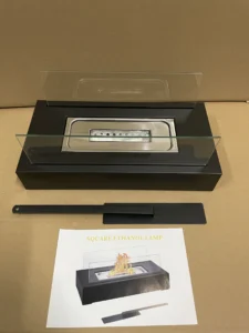 Square tabletop ethanol fireplace displayed with its instruction sheet and extinguisher