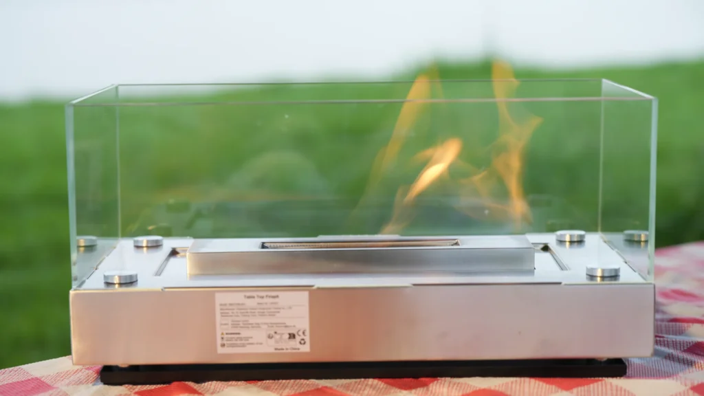 Rectangular stainless steel tabletop ethanol fireplace during a live flame check