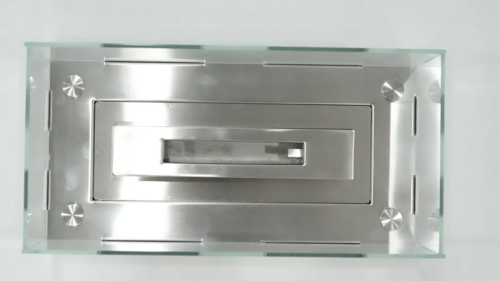 Top view of a rectangular tabletop ethanol fireplace fuel opening and guard structure
